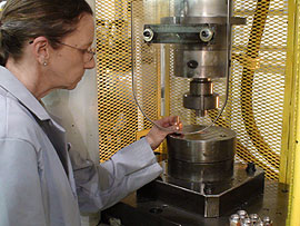 Worker using a specialty cold forming machine