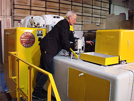 Worker using a specialty cold heading machine